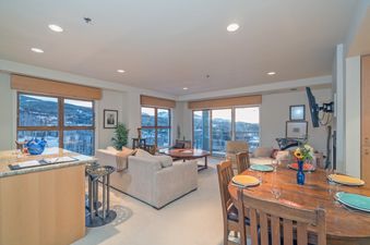 The Penthouse At The Peaks 746 showcases a spacious and bright living area with views of the surrounding mountains.