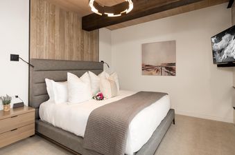 The master bedroom at Moonlight Basin 8A Treeline features a comfortable king bed with plush bedding and a sleek, modern design.