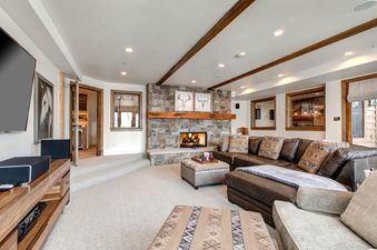 A cozy living room with a fireplace and a large sectional sofa.