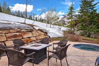 The patio at Equinox at Empire Pass features a fire pit and hot tub.