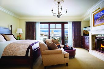 A luxurious bedroom at Montage Four Bedroom Residence Summit View with a four-poster bed and a stunning mountain view from the balcony.