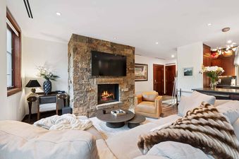 The living area of Solaris 3BS features a cozy fireplace, comfortable seating, and elegant decor, creating a warm and inviting atmosphere.