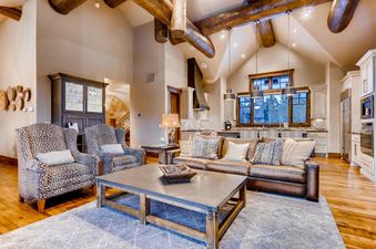 The grand living area of Monarch at Shock Hill features an open-concept design, connecting seamlessly with the kitchen and dining area.
