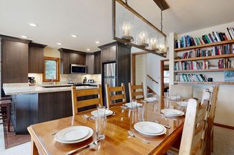 The dining table and kitchen area at Timber Ridge 1.