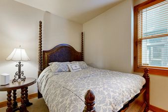 The bedroom at Quittin Time on Woodside features a four-poster bed and a serene atmosphere.
