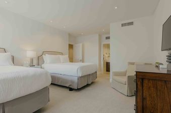 Summit View Chalet bedroom features two queen beds, a large closet, and a private bathroom.