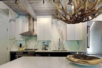 The kitchen of Timberline Two Bedroom D2H features white cabinetry, stainless steel appliances, and a sleek countertop.
