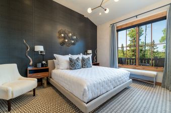 Lost Chalet at Belvedere's bedroom features a plush bed and stylish decor.