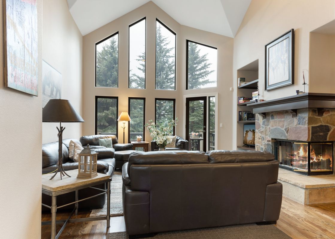 Living room with leather sofas and a fireplace at 11A Castle Peak Close.
