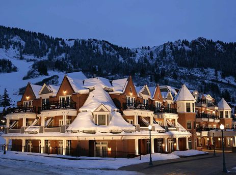 The Hyatt Lodge Room is nestled in a snowy mountain landscape at dusk.