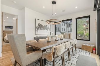 Dining room at Sunrise Ridge at Canyons with a large wooden table and plush chairs.