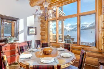 Dining area at Villas At Tristant 221 with a round wooden table and mountain views.