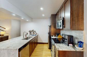 Phoenix 107 kitchen features stainless steel appliances and granite countertops.