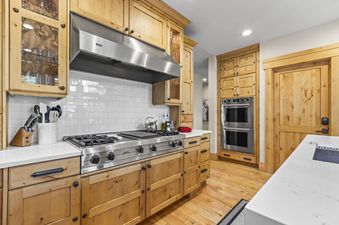 The kitchen in Oak Haven boasts light wood cabinets and stainless steel appliances.