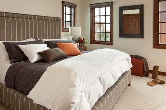Cozy and elegant master bedroom in Shooting Star Cabin 04 with a plush striped bed.