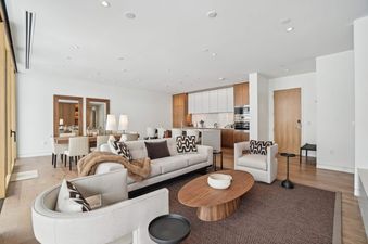 The Founders Place 2304 living area, kitchen, and dining space seamlessly blend in an open-concept design.