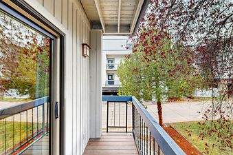 SunRiver E101 offers an expansive balcony overlooking the surrounding trees and landscape.