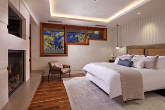 The master bedroom in The Mother Lode features a comfortable king-sized bed and views of the outdoors.