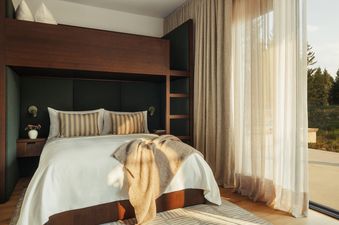 Cozy bedroom with built-in bunk bed, sliding glass door, and scenic view in Four Bedroom Private Home Moonlight Basin.