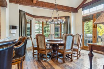 Luxurious dining room at Gore Place with a large round wooden table and beautiful views.