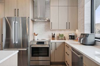 The modern kitchen in One Riverfront Condo 503 features stainless steel appliances and sleek cabinetry.