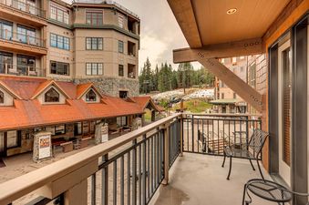 A balcony with a view of the ski resort in the mountains.