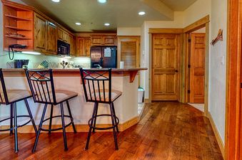 The kitchen of EagleRidge Lodge 211 features a large, open space with plenty of natural light, modern appliances, and a view of the surrounding area.