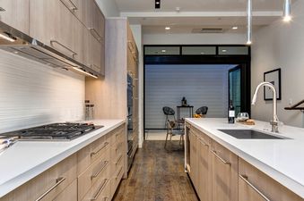 The sleek, modern kitchen at Abode at the Parkite features high-end appliances and finishes.