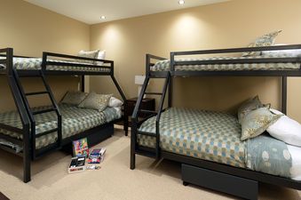 Bunk bedroom in Flat Tops Peak Penthouse One Steamboat Place 701 with two twin-over-queen bunk beds.