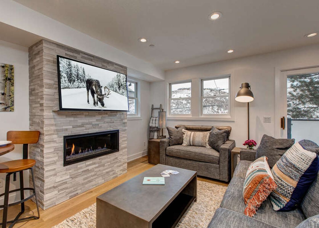Living area at Abode at Pick N Shovel with stone fireplace.