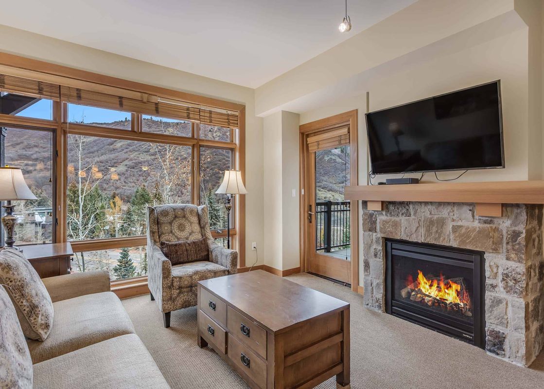 The living room of Capitol Peak Lodge 3207 features a fireplace, a couch and a coffee table.