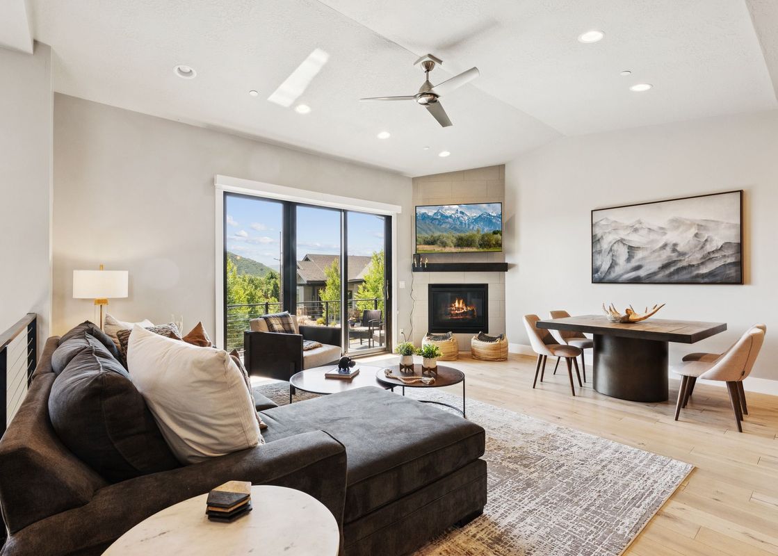 A modern and bright open-concept living and dining area in Holly Frost Chalet.