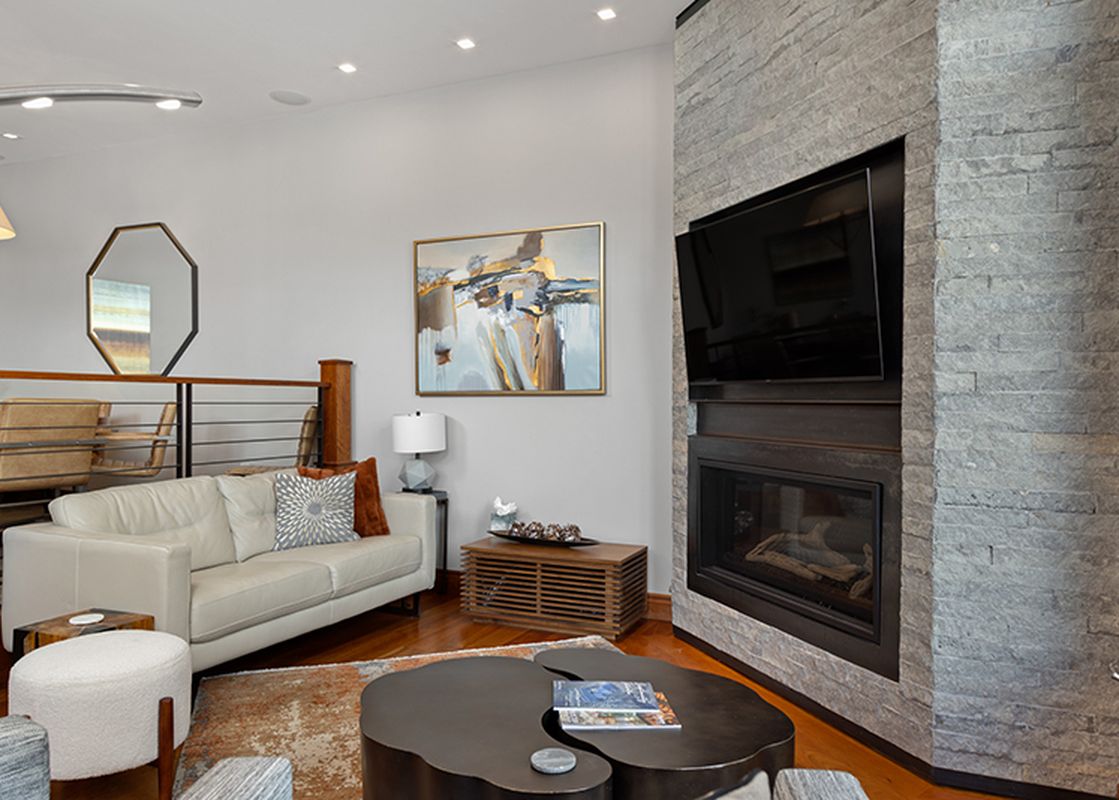 A living room with a fireplace, a couch, and a coffee table.