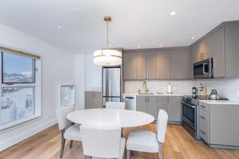 The Peaks Penthouse 334 showcases a modern kitchen and dining area.
