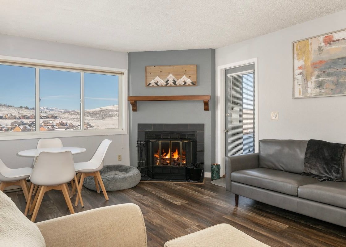 The living area of Summit Unit 1103 is brightly lit from the adjacent window.