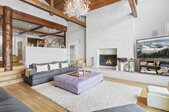 A stylish living room at 6977 Silver Lake Drive featuring a white brick fireplace and a cozy seating area.