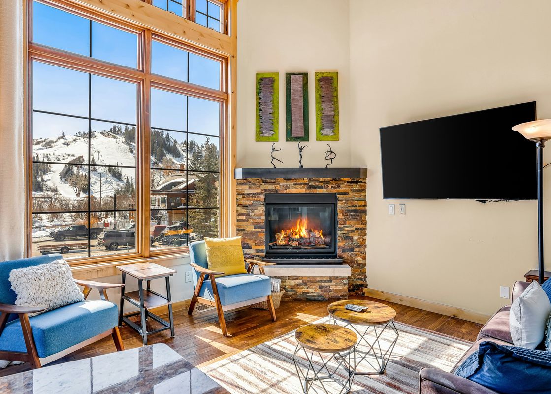 Living room with a fireplace and a view of snow-covered mountains