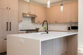 Kitchen with white countertops and a modern faucet