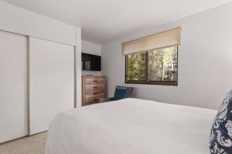 A modern and serene bedroom at Riverview Unit 22.