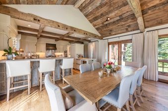 The elegant dining room and open-concept kitchen inside Shooting Star Cabin 05.