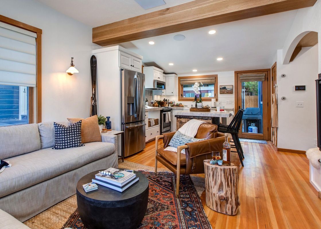 The living room of Alpine Minnies Old Town features a couch, chair, and coffee table.