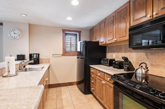The kitchen in Lodge Tower 299 3BR has stainless steel appliances and granite countertops.