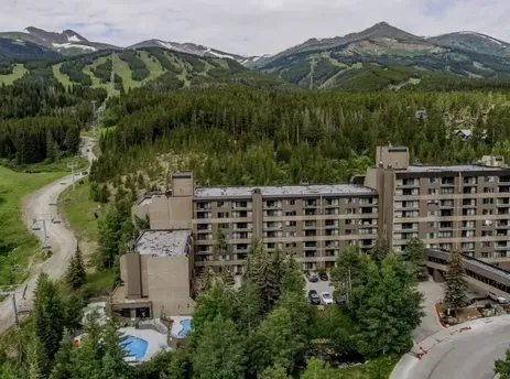 Summit Suite Beaver Run Resort with a forest and mountain backdrop