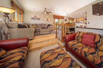 A spacious living area with comfortable seating and rustic decor in Jabberwocky Home.