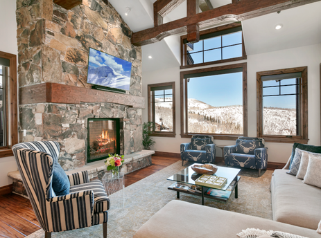 Grand Lodge Four Bedroom 302 living room features a fireplace and a large window with a mountain view.