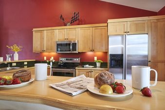 A close-up view of the kitchen counter in Moose Creek 30 set with pastries and coffee.