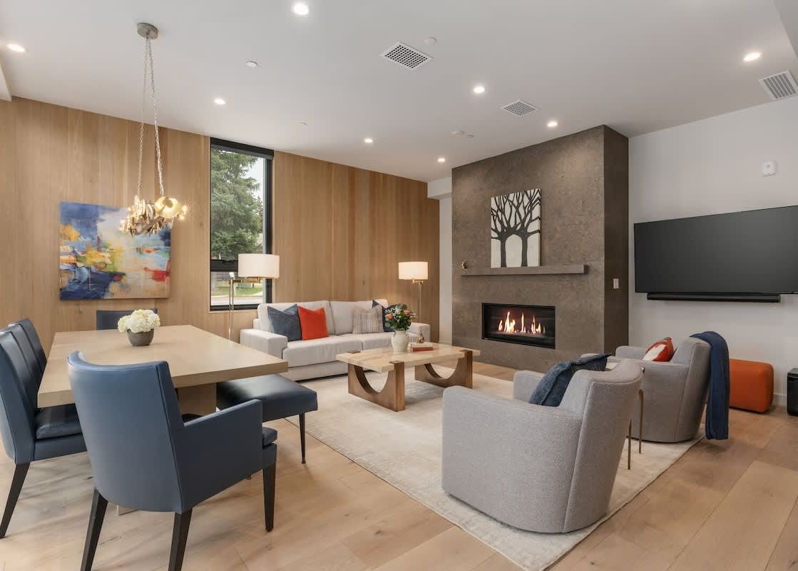 Living and dining area of Sky View Jackson Hole with a fireplace and modern furniture.