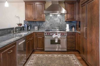 Vail Mountain View 402's kitchen boasts stainless steel appliances, granite countertops, and wood cabinetry.