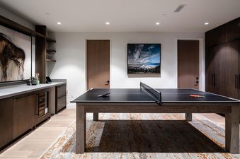 Moonlight Basin 5 Thistle Way features a spacious game room with a ping pong table and a modern design.