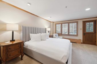 A beautifully appointed bedroom in Lodge Tower 277 3BR features a plush bed and warm, inviting decor.